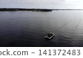 Aquaculture Vessel Actively Managing Mussel Lines Amidst Tranquil Waters In Sheltered Bay Environment . Media 141372483