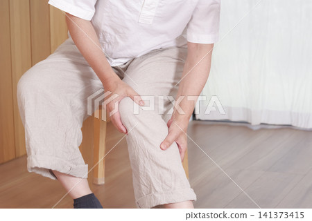 The hands of a middle-aged woman suffering from knee problems The hands of a middle-aged woman suffering from knee problems 141373415