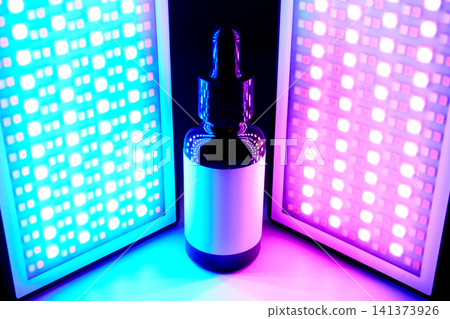 Serum dropper bottle with led light therapy panels offering futuristic skincare 141373926