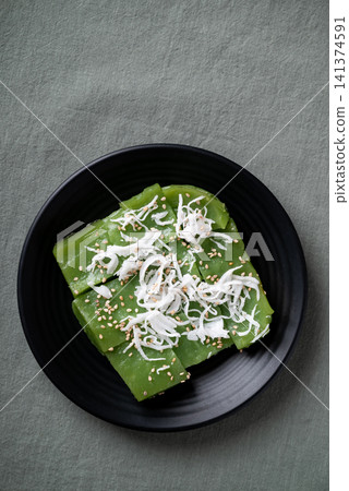 Traditional Thai dessert, pandan sweet pudding topped with coconut and toasted sesame seeds Traditional Thai dessert, pandan sweet pudding topped with coconut and toasted sesame seeds 141374591