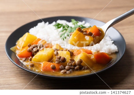 Japanese curry with lentil, carrot, potato and onion eating with cooked rice, Vegetarian food Japanese curry with lentil, carrot, potato and onion eating with cooked rice, Vegetarian food 141374627