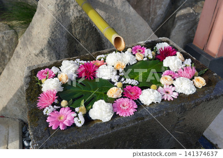 Colorful flower arrangements and bamboo pipes floating on the water's surface Colorful flower arrangements and bamboo pipes floating on the water's surface 141374637
