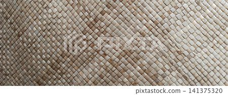 A background featuring the intricate texture of a hand-woven palm leaf mat. A background featuring the intricate texture of a hand-woven palm leaf mat. 141375320