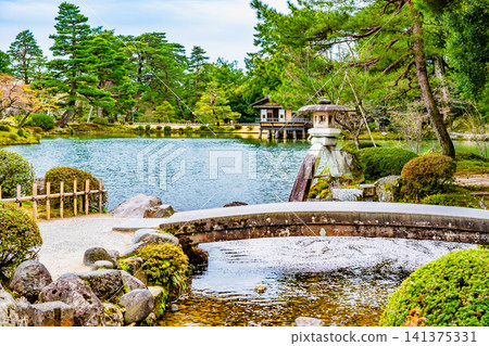 Kanazawa Kenrokuen Garden: Kasumigaike Pond with cherry blossom petals floating on it Kanazawa Kenrokuen Garden: Kasumigaike Pond with cherry blossom petals floating on it 141375331