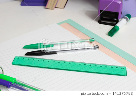School supplies for students, including pens, a ruler, and notebooks, preparing for learning and education, back to school concept on a white desk School supplies for students, including pens, a ruler, and notebooks, preparing for learning and education, back to school concept on a white desk 141375798