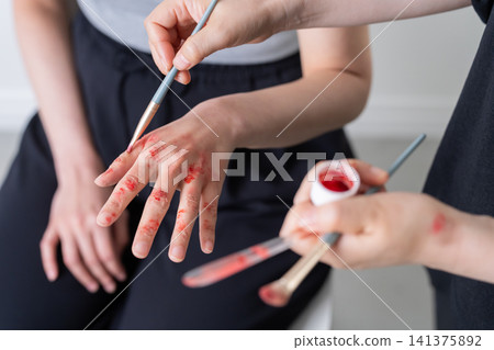 Makeup artist who applies special effects makeup to actors Makeup artist who applies special effects makeup to actors 141375892