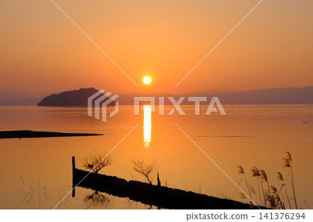 A sunset view of Lake Biwa and Chikubu Island. 141376294