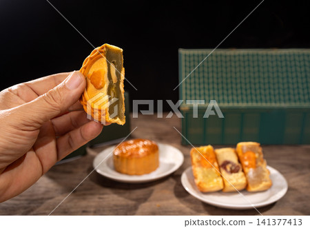 Traditional Mooncakes for Mid-Autumn Festival Celebration on Dark Background. Traditional Mooncakes for Mid-Autumn Festival Celebration on Dark Background. 141377413