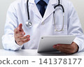 A doctor using a digital tablet PC for medical examinations. He is wearing a white coat and a stethoscope around his neck. 141378177
