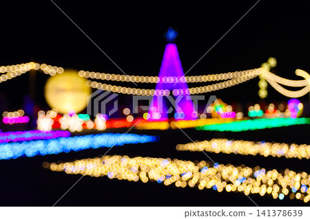 Christmas tree and garden decoration with beautiful bokeh lighting at night. Outdoor winter illumination festival event landscape display Christmas tree and garden decoration with beautiful bokeh lighting at night. Outdoor winter illumination festival event landscape display 141378639