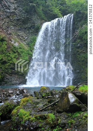 The spray of water from Zengoro Falls The spray of water from Zengoro Falls 141378812