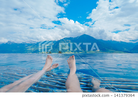 Overlooking mountains and lakes from a swimming pool in Switzerland Overlooking mountains and lakes from a swimming pool in Switzerland 141379364