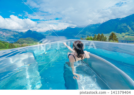 Overlooking mountains and lakes from a swimming pool in Switzerland Overlooking mountains and lakes from a swimming pool in Switzerland 141379404