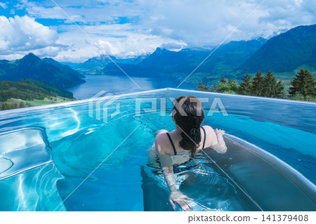 Overlooking mountains and lakes from a swimming pool in Switzerland Overlooking mountains and lakes from a swimming pool in Switzerland 141379408