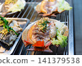 Grilled whole fish topped fresh herbs served lettuce showcasing flavorful seafood cuisine freshly prepared for delicious meal 141379538