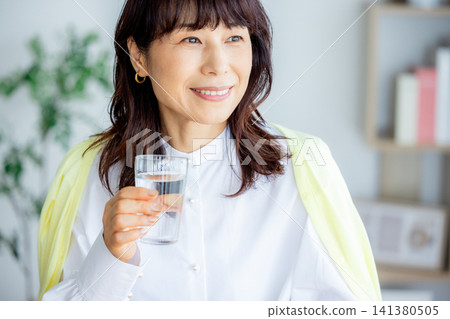 一杯水在客廳裡的中年女人 141380505