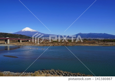 Mount Fuji and Mount Ashitaka stand out against the clear blue sky, with the Tomei Expressway and the Fujikawa River flowing by in the background. January, Mount Fuji 2253, Tomei Expressway and Fujikawa River Mount Fuji and Mount Ashitaka stand out against the clear blue sky, with the Tomei Expressway and the Fujikawa River flowing by in the background. January, Mount Fuji 2253, Tomei Expressway and Fujikawa River 141380867