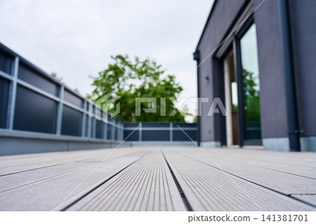 Modern terrace with composite decking outside contemporary home Modern terrace with composite decking outside contemporary home 141381701