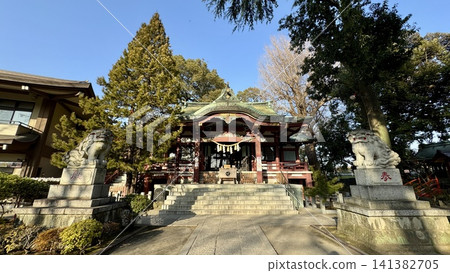 Ornate neighborhood shrine building under blue sky 141382705
