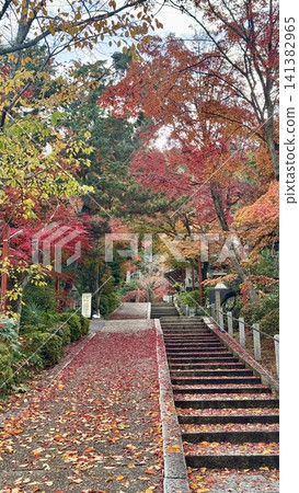 Whimsical stacked tanuki statues in a green forest Whimsical stacked tanuki statues in a green forest 141382965