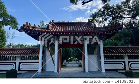 Traditional Chinese gate opening onto a formal garden Traditional Chinese gate opening onto a formal garden 141383025