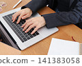 The hands of a business person working on a laptop 141383058