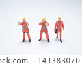 Miniature construction workers stand on plain white background. 141383070