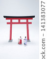 Miniature Shinto priest and maiden by torii gate. 141383077