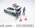 Miniature Japanese police officers stand by patrol car. 141383081