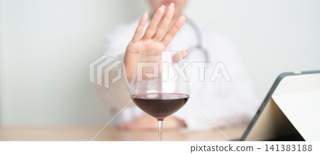 Doctor hand stop to refuse Wine, quitting drink for healthy liver, prevent Alcoholic cirrhosis and cancer, World No Alcohol Day, medical advice for sobriety and Alcoholism and addiction concept Doctor hand stop to refuse Wine, quitting drink for healthy liver, prevent Alcoholic cirrhosis and cancer, World No Alcohol Day, medical advice for sobriety and Alcoholism and addiction concept 141383188