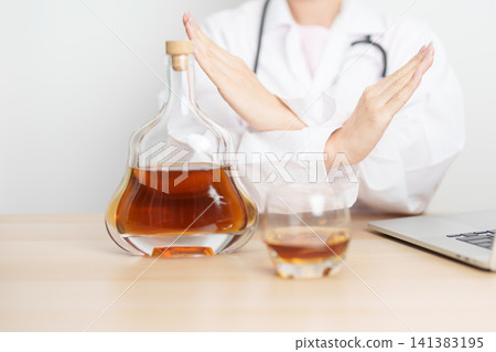 Doctor hand stop to refuse Whisky, quitting drink for healthy liver, prevent Alcoholic cirrhosis and cancer, World No Alcohol Day, medical advice for sobriety and Alcoholism and addiction concept Doctor hand stop to refuse Whisky, quitting drink for healthy liver, prevent Alcoholic cirrhosis and cancer, World No Alcohol Day, medical advice for sobriety and Alcoholism and addiction concept 141383195