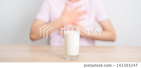 Lactose intolerance and Milk allergy concept. woman with Milk glass and having abdominal cramps and pain when drink Cow Milk. Symptom stomach ache, Dairy intolerant, Nausea, Bloating, Gas and Diarrhea Lactose intolerance and Milk allergy concept. woman with Milk glass and having abdominal cramps and pain when drink Cow Milk. Symptom stomach ache, Dairy intolerant, Nausea, Bloating, Gas and Diarrhea 141383247