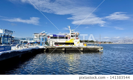 Passenger ferry docked in a bright winter harbor 141383544