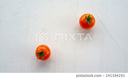 Two ripe cherry tomatoes on bright white textured surface with clean minimal composition, fresh red color, green stems, soft daylight, plenty of copy space, simple food concept, healthy ingredient Two ripe cherry tomatoes on bright white textured surface with clean minimal composition, fresh red color, green stems, soft daylight, plenty of copy space, simple food concept, healthy ingredient 141384291