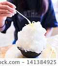 Eating shaved ice [A summer tradition] 141384925