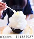 Eating shaved ice [A summer tradition] 141384927