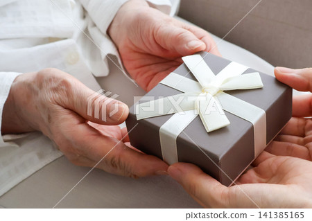 An elderly woman's hands receiving a gift - Respect for the Aged Day image 141385165