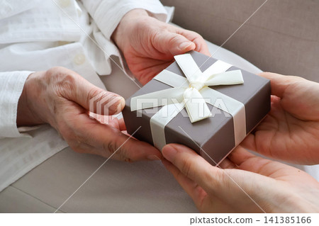 An elderly woman's hands receiving a gift - Respect for the Aged Day image An elderly woman's hands receiving a gift - Respect for the Aged Day image 141385166