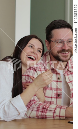 Vertical video Young family signing agreement with housing agent buying apartment getting keys. Couple moving to new apartment. Real estate concept. Vertical video Young family signing agreement with housing agent buying apartment getting keys. Couple moving to new apartment. Real estate concept. 141385222