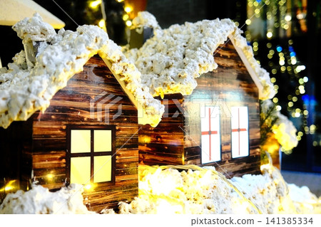 Winter village homes glowing under soft light Winter village homes glowing under soft light 141385334