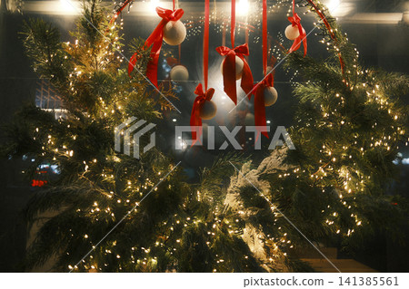 Festive evergreen branches with glowing lights Festive evergreen branches with glowing lights 141385561