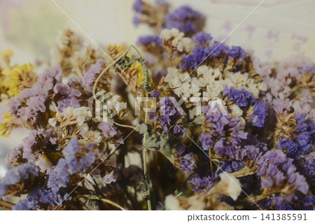 Bouquet of dried statice flowers in purple, yellow and white colors. Aesthetic natural decor for eco-friendly interior styling Bouquet of dried statice flowers in purple, yellow and white colors. Aesthetic natural decor for eco-friendly interior styling 141385591
