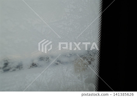 Frosty car windshield on a cold winter day Frosty car windshield on a cold winter day 141385626