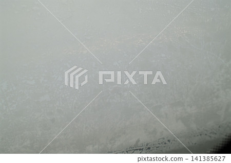 Ice crystals form on a frozen car window Ice crystals form on a frozen car window 141385627