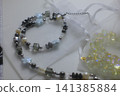 Colorful beaded necklaces displaying blue flower beads, grey stone beads 141385884