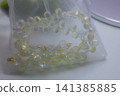 A delicate iridescent beaded bracelet with teardrop shaped glass beads and gold accents 141385885