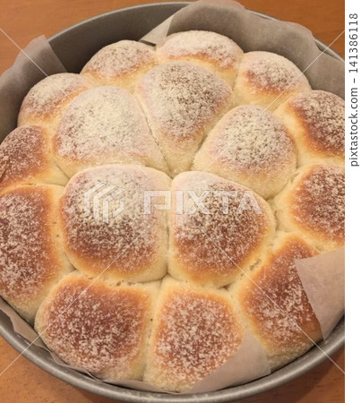 Homemade pull-apart bread, baked to perfection and filling the mold. Homemade pull-apart bread, baked to perfection and filling the mold. 141386118