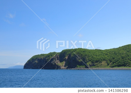 The view of Cape Puyuni on the Shiretoko Peninsula from a boat. The view of Cape Puyuni on the Shiretoko Peninsula from a boat. 141386298