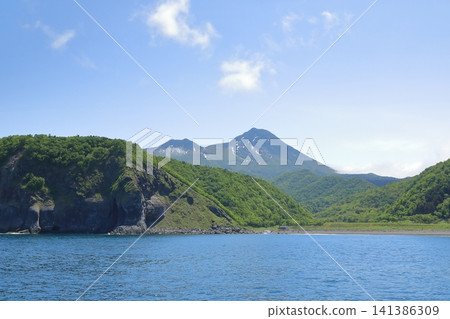 A view of Mount Rausu with lingering snow, seen from the Sea of Okhotsk. A view of Mount Rausu with lingering snow, seen from the Sea of Okhotsk. 141386309