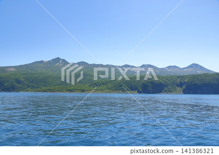 The magnificent scenery of the Shiretoko mountain range as seen from the Sea of Okhotsk. The magnificent scenery of the Shiretoko mountain range as seen from the Sea of Okhotsk. 141386321